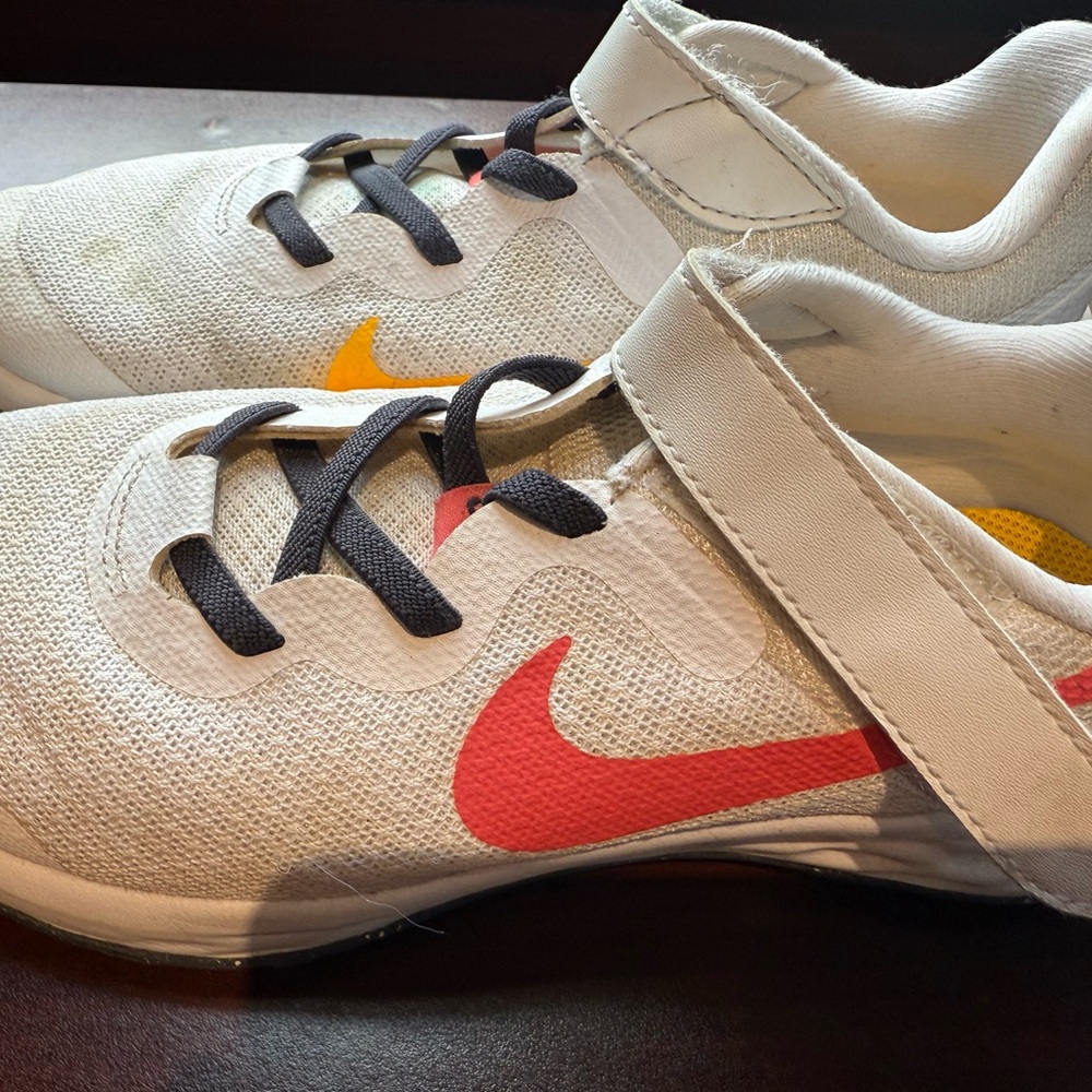 Nike Kids White Sneakers with Red Swoosh and Yellow Accent
